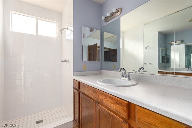 bathroom with tiled shower and oversized vanity