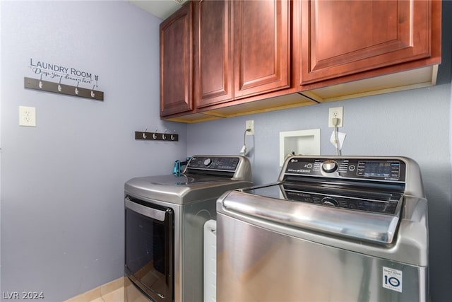 clothes washing area featuring cabinets, hookup for a washing machine, and separate washer and dryer