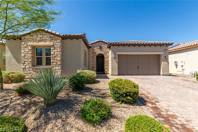 mediterranean / spanish-style home with a garage