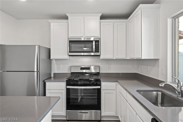 kitchen featuring sink, white cabinets, and appliances with stainless steel finishes