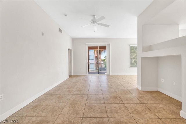 tiled empty room with ceiling fan