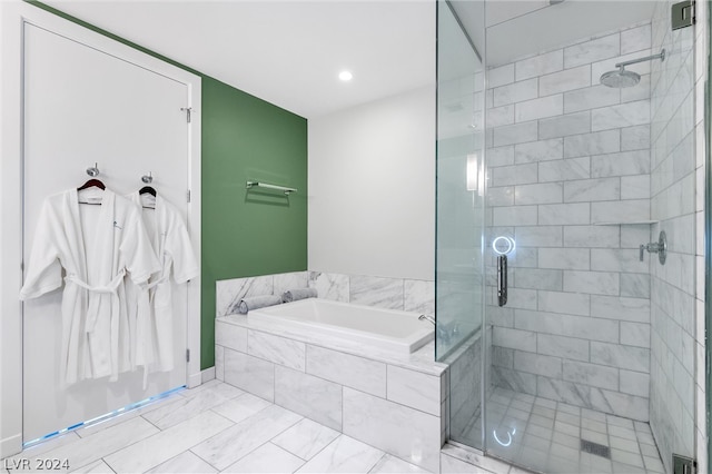 bathroom featuring tile floors and shower with separate bathtub