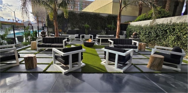 view of patio featuring an outdoor living space and a fenced in pool