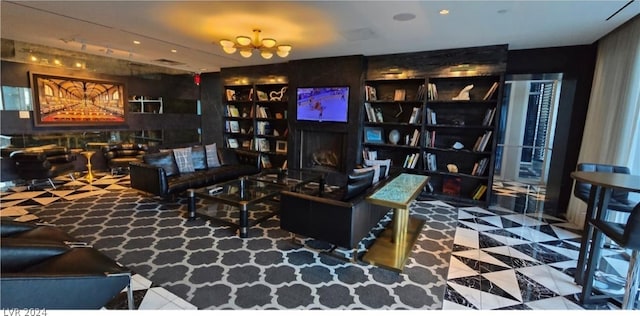 living room featuring tile flooring, a chandelier, and a large fireplace