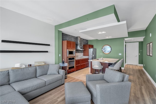 living room featuring sink and hardwood / wood-style flooring