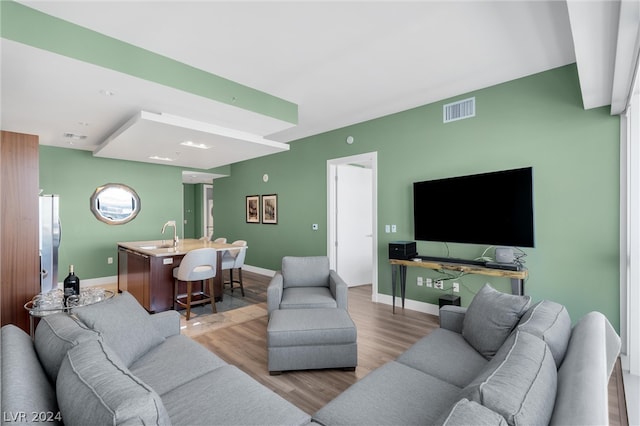 living room with sink and hardwood / wood-style flooring