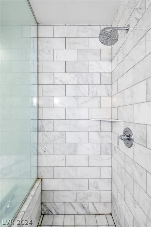 bathroom with tiled shower