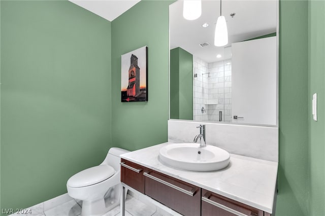 bathroom with tile flooring, toilet, and vanity