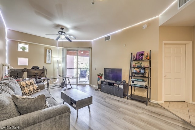 living room with ceiling fan and light tile flooring