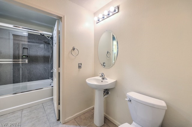 bathroom with tile flooring, toilet, and  shower combination