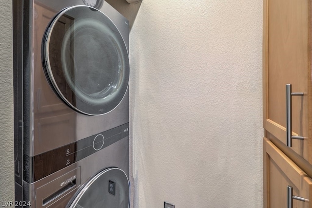 laundry room with stacked washer and dryer