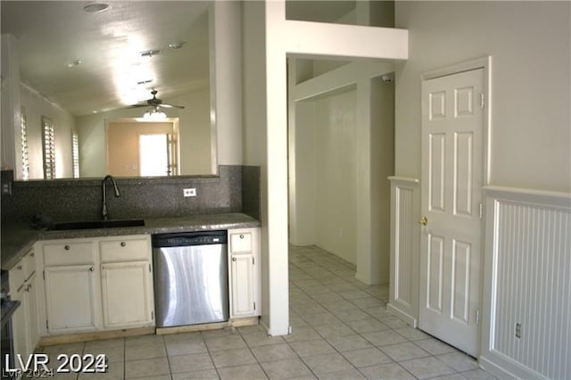 kitchen featuring lofted ceiling, backsplash, white cabinets, sink, and stainless steel dishwasher