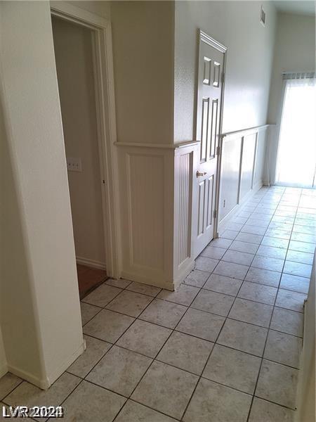 corridor with light tile patterned floors