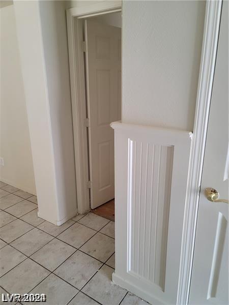 hall with light tile patterned flooring