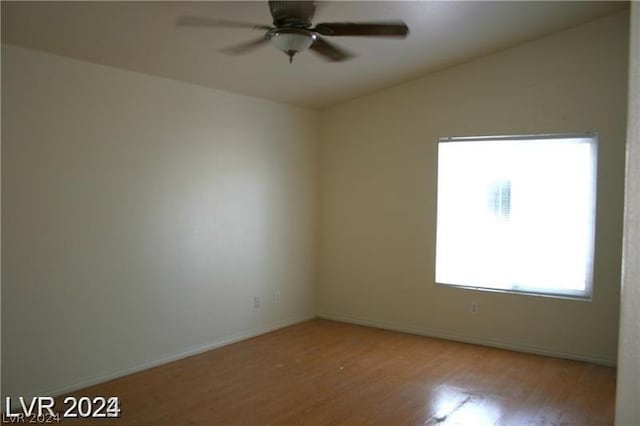 spare room featuring ceiling fan and light hardwood / wood-style flooring