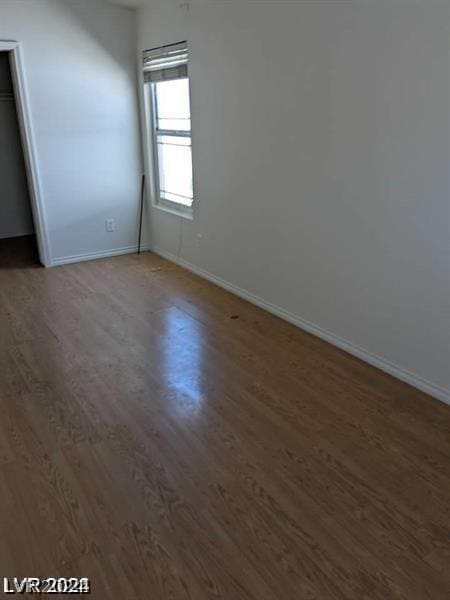 empty room featuring dark wood-type flooring