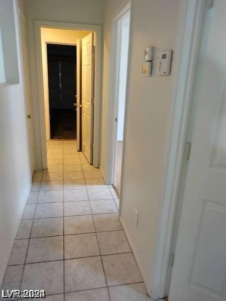 hallway featuring light tile patterned flooring