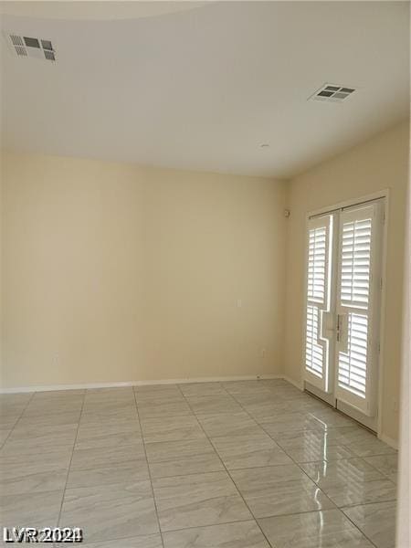 empty room featuring french doors