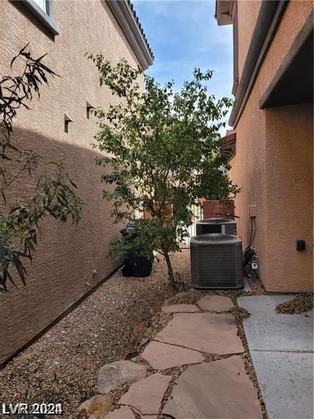 exterior space with cooling unit and a patio