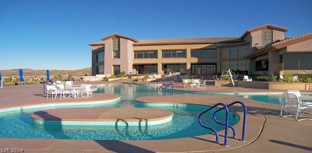 view of swimming pool featuring a patio and a mountain view