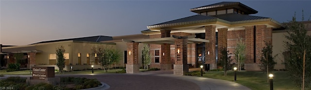 view of outdoor building at dusk