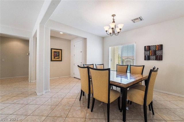 tiled dining area featuring a notable chandelier