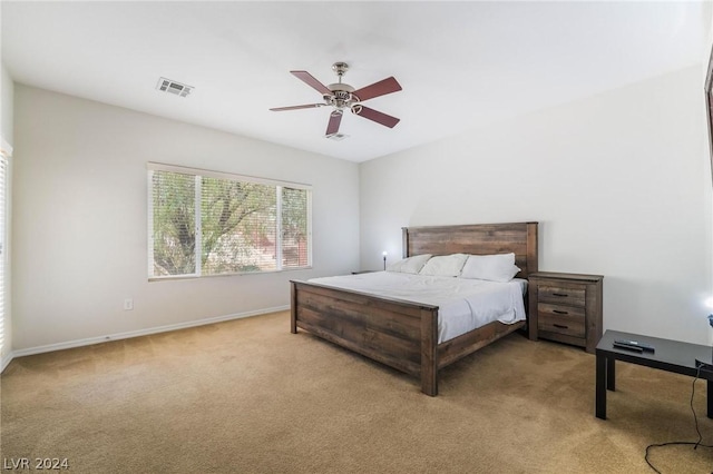 bedroom featuring light carpet and ceiling fan