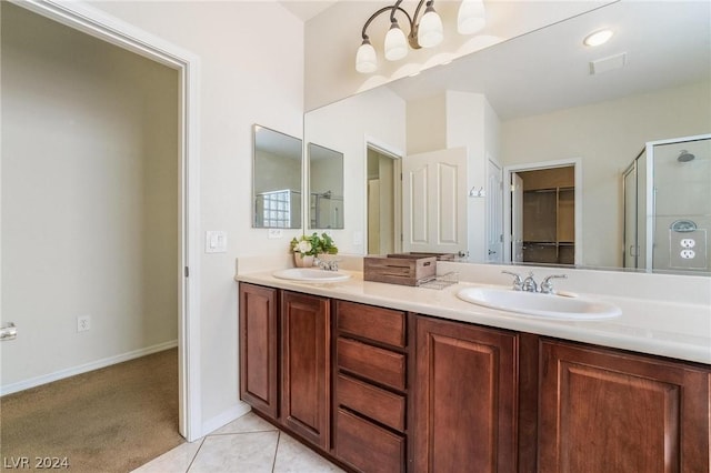 bathroom featuring vanity, a shower with door, and tile patterned floors