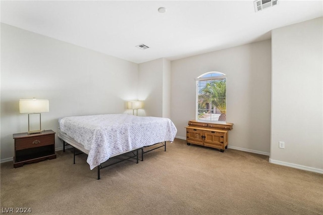 bedroom featuring light colored carpet