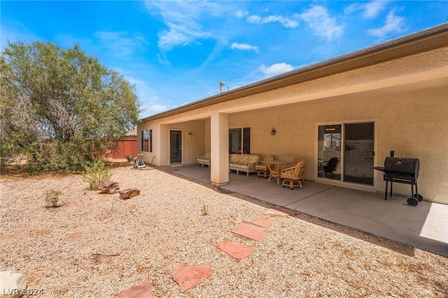 back of property with outdoor lounge area and a patio area