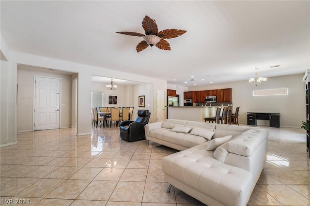 living room featuring light tile patterned flooring and ceiling fan with notable chandelier