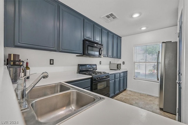 kitchen featuring sink, blue cabinets, and black appliances