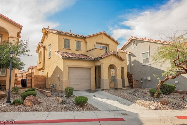 1161 Gecko Rd, Henderson, NV 89002 - mediterranean / spanish-style house with a tile roof, stucco siding, concrete driveway, a garage, and fence