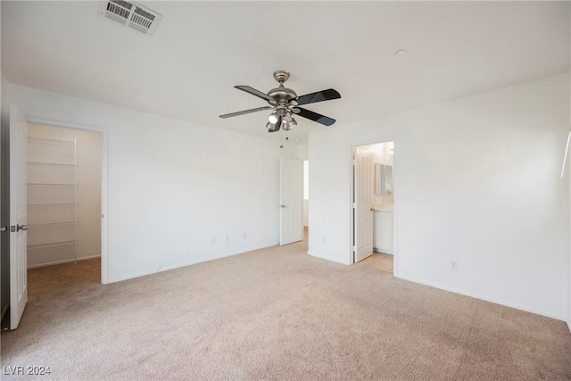 1161 Gecko Rd, Henderson, NV 89002 - unfurnished bedroom with light carpet, a spacious closet, baseboards, ensuite bath, and ceiling fan