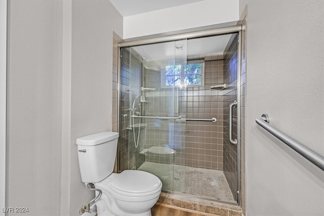 bathroom with walk in shower and toilet