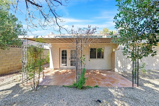 back of house with french doors and a patio