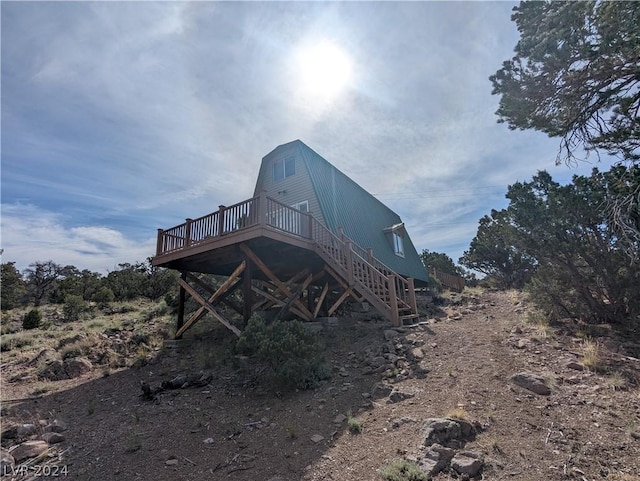 rear view of property with a wooden deck