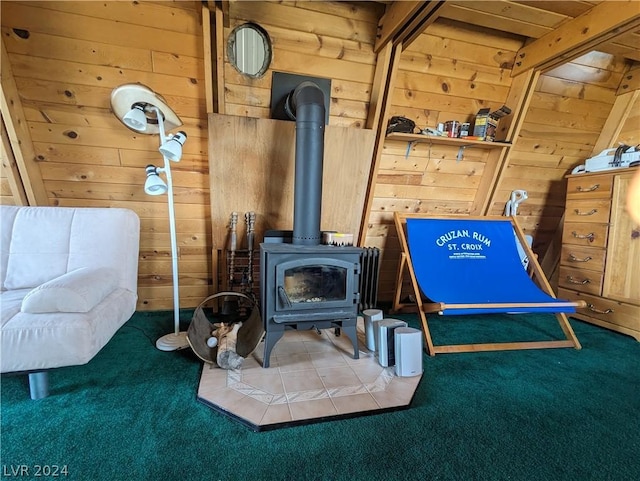 interior details with carpet flooring, a wood stove, and wooden walls