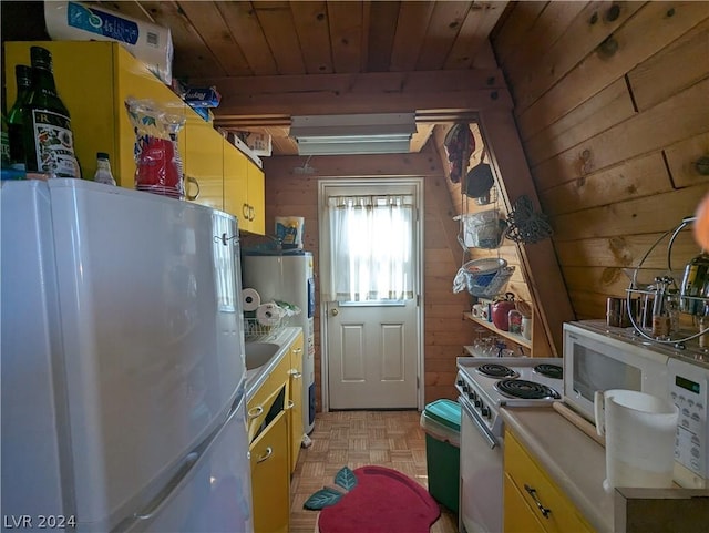 kitchen featuring wooden ceiling, white appliances, wooden walls, water heater, and light parquet flooring