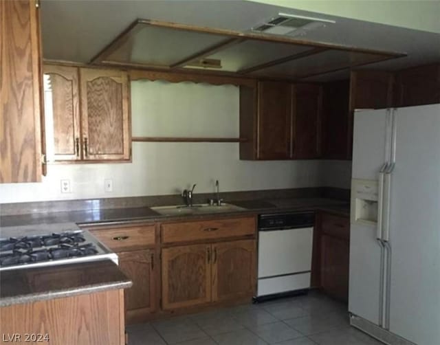 kitchen with sink, white appliances, and light tile patterned floors