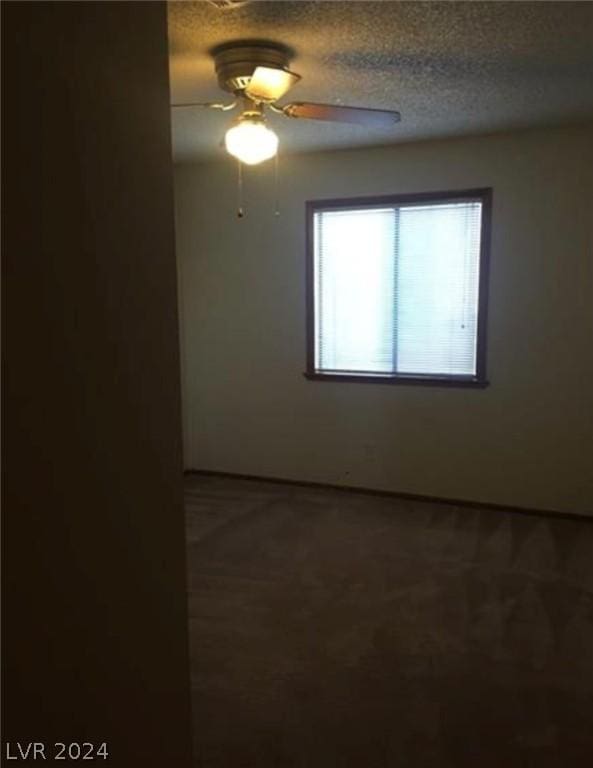 spare room featuring ceiling fan and a textured ceiling