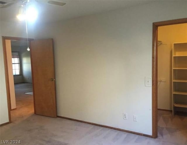 unfurnished bedroom featuring light carpet