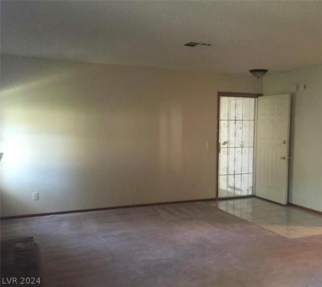 unfurnished room with light carpet