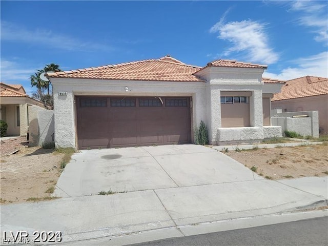 mediterranean / spanish-style house with a garage