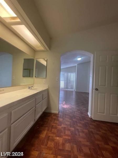 bathroom with vanity and parquet floors