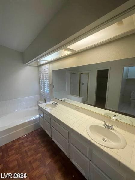 bathroom with a bathing tub, vanity, and parquet flooring