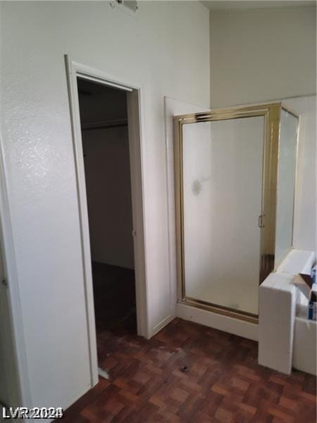 bathroom featuring parquet flooring and a shower with door