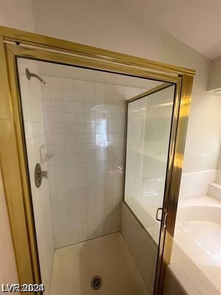 bathroom with vaulted ceiling and an enclosed shower