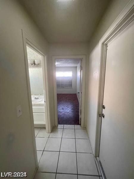 hall featuring light tile patterned flooring