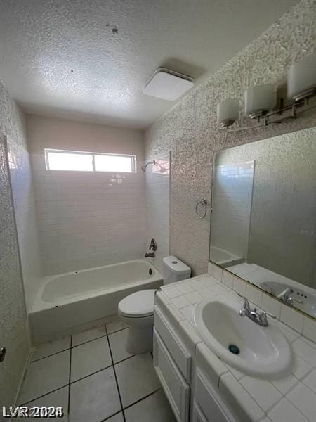 full bathroom with vanity, a textured ceiling, tile patterned floors, and tiled shower / bath